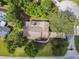 Aerial view of the home showcasing its roof, driveway, and surrounding mature trees at 6642 Parson Brown Dr, Orlando, FL 32819