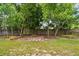 A charming backyard featuring well-maintained grass, landscaping, and partial fence lines at 6642 Parson Brown Dr, Orlando, FL 32819