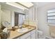 Light filled bathroom with large framed mirror and tiled floor at 6642 Parson Brown Dr, Orlando, FL 32819