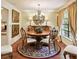 Elegant dining room featuring a round table, decorative chandelier, and a picturesque window view at 6642 Parson Brown Dr, Orlando, FL 32819
