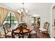 Charming dining room with natural light, an elegant chandelier, and classic furnishings at 6642 Parson Brown Dr, Orlando, FL 32819