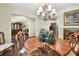 Elegant dining room featuring a round table, ornate chandelier, and access to additional living spaces at 6642 Parson Brown Dr, Orlando, FL 32819