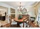 Bright dining room with hardwood floors, ornate decor, and a seamless flow to adjacent living spaces at 6642 Parson Brown Dr, Orlando, FL 32819