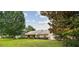 Inviting single-story home with a brick facade, manicured lawn, and mature landscaping at 6642 Parson Brown Dr, Orlando, FL 32819