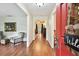 Inviting foyer with hardwood floors, open access to living spaces, and a welcoming red front door at 6642 Parson Brown Dr, Orlando, FL 32819