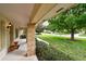Welcoming front porch featuring brick columns, manicured landscaping, and a scenic neighborhood view at 6642 Parson Brown Dr, Orlando, FL 32819