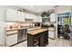 Well-equipped kitchen with stainless steel appliances, tile flooring, and a functional center island at 6642 Parson Brown Dr, Orlando, FL 32819