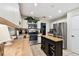 Modern kitchen featuring stainless steel appliances, a center island, and tile flooring at 6642 Parson Brown Dr, Orlando, FL 32819