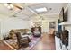 Inviting living room featuring a brick fireplace, ample natural light, and comfortable seating at 6642 Parson Brown Dr, Orlando, FL 32819