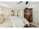 A comfortable main bedroom featuring a beautiful antique armoire and a relaxing atmosphere at 6642 Parson Brown Dr, Orlando, FL 32819
