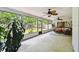 Bright sunroom with large windows and a comfortable seating area with ceiling fans overlooking the backyard at 6642 Parson Brown Dr, Orlando, FL 32819