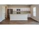 Bright kitchen featuring stainless steel appliances, a large island, and sleek white cabinetry at 1229 Tidal St, Haines City, FL 33844
