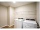 Laundry room with washer, dryer, and wire shelf at 1229 Tidal St, Haines City, FL 33844
