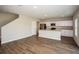 Open-concept layout with wood flooring, connecting the living room to the modern kitchen at 1229 Tidal St, Haines City, FL 33844