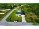 Aerial view of home in a suburban neighborhood, featuring well-manicured lawns and tree coverage at 1430 Tern Ct, Poinciana, FL 34759