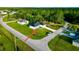 A bird's-eye view of a white single-Gathering home on a well-manicured corner lot at 1430 Tern Ct, Poinciana, FL 34759