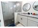Modern bathroom featuring a glass-enclosed shower, granite countertop, and double vanity for added convenience at 1430 Tern Ct, Poinciana, FL 34759