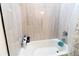 This bathroom has stylish white tiling and modern fixtures at 1430 Tern Ct, Poinciana, FL 34759