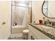 The bathroom offers a granite countertop, modern vanity, and tiled shower-tub combo at 1430 Tern Ct, Poinciana, FL 34759