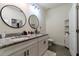 Bathroom with double vanity with granite countertop and modern fixtures offers a luxurious experience at 1430 Tern Ct, Poinciana, FL 34759