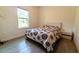 Cozy bedroom featuring light tile flooring, a window and a comfortable bed at 1430 Tern Ct, Poinciana, FL 34759