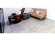 Comfortable bedroom with tiled floor, gaming chair and futon, great for guests or flex space at 1430 Tern Ct, Poinciana, FL 34759
