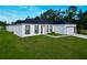 A well-maintained home with a lush green lawn and a two car garage, perfect for a Gathering at 1430 Tern Ct, Poinciana, FL 34759