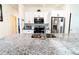 Bright kitchen with a granite countertop island, stainless steel appliances, and white cabinets at 1430 Tern Ct, Poinciana, FL 34759