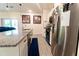 Well-lit kitchen with granite countertops, stainless steel appliances, and tile flooring at 1430 Tern Ct, Poinciana, FL 34759