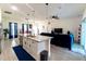 Modern kitchen island with stainless steel appliances and open view to living room at 1430 Tern Ct, Poinciana, FL 34759