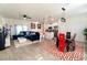 Bright, open-concept living space with modern kitchen, dining area, and a plush blue sofa at 1430 Tern Ct, Poinciana, FL 34759