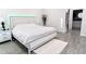 Bright main bedroom with large bed, en suite bathroom and neutral color palette at 1430 Tern Ct, Poinciana, FL 34759
