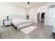 A spacious main bedroom with white furniture, including a bed with a jeweled headboard at 1430 Tern Ct, Poinciana, FL 34759