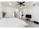 Spacious main bedroom with ceiling fan, tv, and ensuite bathroom, offers comfort and convenience at 1430 Tern Ct, Poinciana, FL 34759