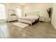 Bright main bedroom features a white bedroom set, neutral walls, and tiled floors for a stylish look at 1430 Tern Ct, Poinciana, FL 34759