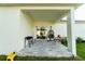 Covered patio offers a relaxing outdoor space, complete with tile flooring and a comfortable egg chair at 1430 Tern Ct, Poinciana, FL 34759