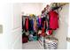 Walk-in closet with ample storage, featuring shelving and rods for organizing clothing and accessories at 1430 Tern Ct, Poinciana, FL 34759