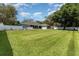 Large backyard with manicured lawn and white picket fence, offering privacy and ample space at 1610 Sherwood Lakes Blvd, Lakeland, FL 33809