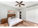 Bedroom featuring wood-look floors, ceiling fan, neutral paint and a double door closet at 1610 Sherwood Lakes Blvd, Lakeland, FL 33809