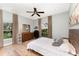 Bedroom featuring wood-look floors, neutral paint and two large windows at 1610 Sherwood Lakes Blvd, Lakeland, FL 33809
