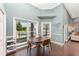 Dining area with hardwood floors and large windows with a view to the pool at 1610 Sherwood Lakes Blvd, Lakeland, FL 33809