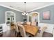 Open-concept dining room with hardwood floors, comfortable seating, and archway to adjacent room at 1610 Sherwood Lakes Blvd, Lakeland, FL 33809