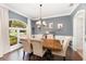 Elegant dining room with hardwood floors, chandelier, and comfortable seating for six at 1610 Sherwood Lakes Blvd, Lakeland, FL 33809