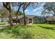 Charming single-story home with well-maintained lawn, colorful flowerbeds, and inviting curb appeal at 1610 Sherwood Lakes Blvd, Lakeland, FL 33809
