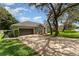 Lovely one-story home with a spacious driveway surrounded by mature trees and lush green grass at 1610 Sherwood Lakes Blvd, Lakeland, FL 33809