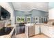 Kitchen featuring white cabinetry, stainless steel appliances, granite counters and view of backyard pool at 1610 Sherwood Lakes Blvd, Lakeland, FL 33809