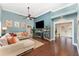 Cozy living room with hardwood floors, high ceilings, fireplace, and comfortable sectional sofa at 1610 Sherwood Lakes Blvd, Lakeland, FL 33809