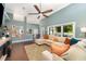 Bright living room with vaulted ceiling, hardwood floors, large windows, and comfortable sectional sofa at 1610 Sherwood Lakes Blvd, Lakeland, FL 33809