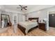 Main bedroom features tray ceiling, wood floors and exterior access to outdoor patio at 1610 Sherwood Lakes Blvd, Lakeland, FL 33809