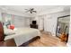 Main bedroom featuring decorative tray ceiling, wood floors, ceiling fan and ensuite bathroom at 1610 Sherwood Lakes Blvd, Lakeland, FL 33809